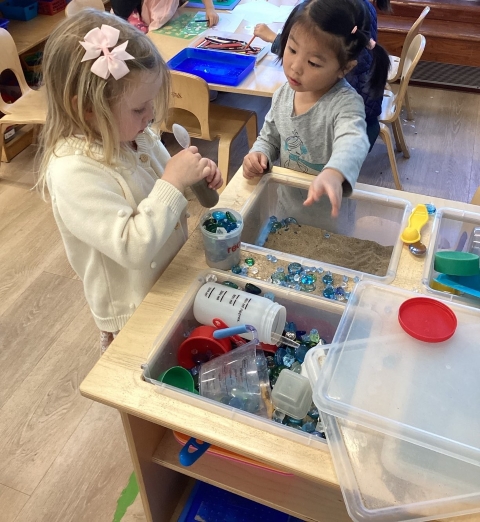 2 preschoolers at sensory table